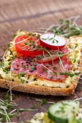 Sandwiches with cream cheese, vegetables and salami.