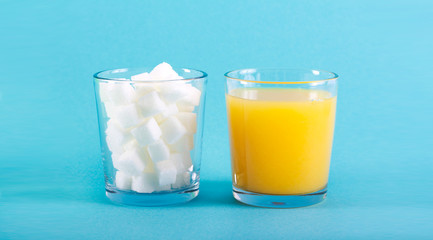 Glass of drink and glass of sugar