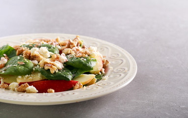 Spinach and apple salad on plate