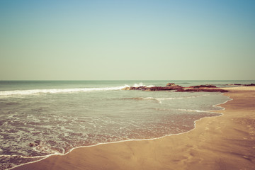 Landscape, beach in the Indian ocean, waves and rocks