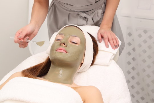 Woman Having Cosmetic Facial Seaweed Treatment In Spa.