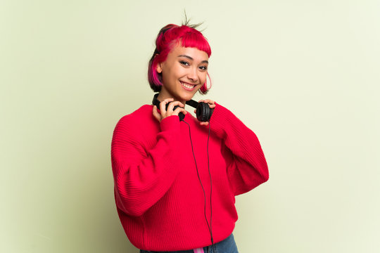 Young woman with red sweater with headphones