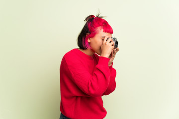 Young woman with red sweater holding a camera