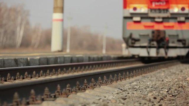 The wheels of old train on the railway track passing by camera. Close up shot