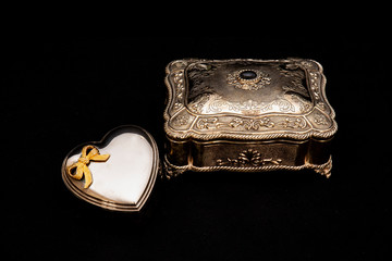 Silver vintage square jewelry box and metal heart-shaped box, black background