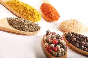 Group of indian spices and herbs difference ware in wooden spoons on white background for design foods, vegetable, spices, herbs, healthy lifestyle