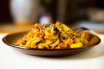 Vegetarian curry with noodle udon on plate.