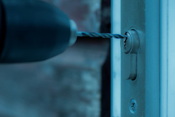 a burglar digs the lock on a house