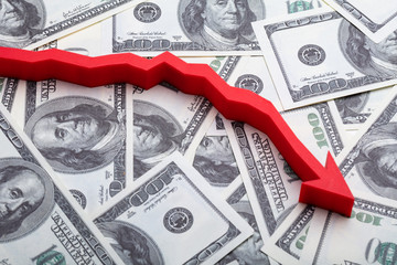 Red Decreasing Arrow Sign Over Banknotes