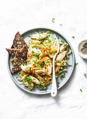 Cabbage chicken fillet stewed on a light background, top view. Healthy diet food concept