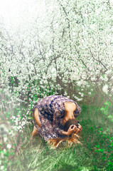 Young depressed and desperate woman crying alone suffering stress and depression crisis being victim of separate suffering bullying and abuse on white spring flowers