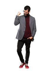 Handsome man with glasses celebrating a victory over isolated white background