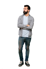 Handsome man with beard with confuse face expression over isolated white background