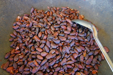 Roasting fresh cocoa beans in a large skillet in Costa Rica