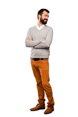 Fototapeta premium Handsome man with arms crossed and happy over isolated white background
