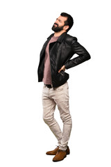 Naklejka premium Handsome man with beard suffering from backache for having made an effort over isolated white background
