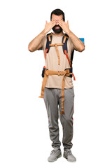 Fototapeta premium Hiker man covering eyes by hands over isolated white background