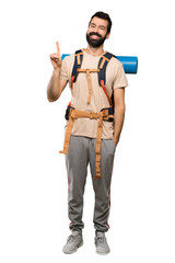 Hiker man showing and lifting a finger in sign of the best over isolated white background