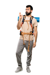 Naklejka premium Hiker man with fingers crossing and wishing the best over isolated white background