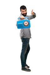 Handsome man with beard holding a radio