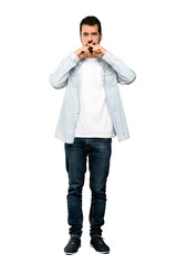 Fototapeta premium Full-length shot of Handsome man with beard showing a sign of silence gesture over isolated white background