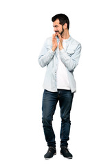 Full-length shot of Handsome man with beard scheming something over isolated white background