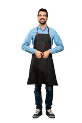 Full-length shot of Man with apron laughing over isolated white background