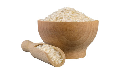 arborio risotto short grain rice in wooden bowl and scoop isolated on white background. nutrition. bio. natural food ingredient.
