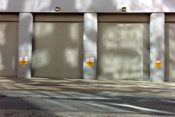sidewalk and garage door entrance with light, shadow and reflection 