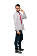 Full-length shot of Handsome man with beard with glasses and smiling over isolated white background