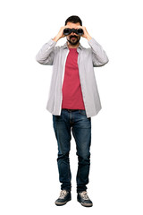 Handsome man with beard  with binoculars.