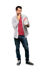 Handsome man with beard  holding a little house