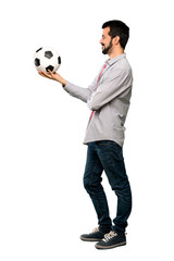 Handsome man with beard holding a soccer ball