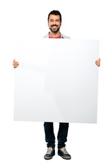 Handsome man with beard  holding an empty placard