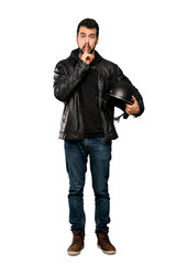 Fototapeta premium Full-length shot of Biker man showing a sign of silence gesture putting finger in mouth over isolated white background