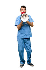 Full-length shot of Surgeon doctor man shouting through a megaphone over isolated white background