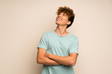 African american man with green shirt looking up while smiling