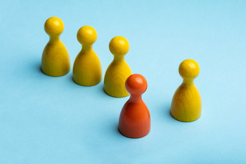 Obraz premium Red And Yellow Wooden Game Pawns On Plain Background