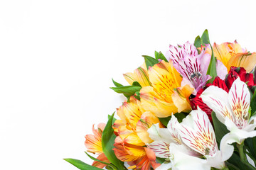 Bouquet of colorful flowers alstroemeria on white background. Flat lay. Horizontal. Mockup with copy space for greeting card, social media, flower delivery, Mother's day, Women's Day.