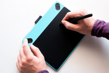 illustrator designer draws on graphic tablet on white background
