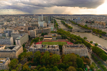 Aerial view of Paris city with Seine river from the top of Eiffel tower in cloudy day