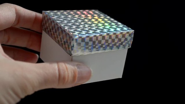 White gift box with rainbow scotch cover, DIY idea, the box is opened in hands