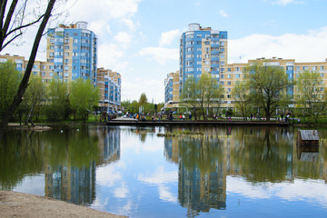 A small pond in the city, which is reflected in the water.
