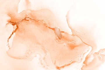 Orange alcohol ink texture with abstract washes and paint stains on the white paper background.	