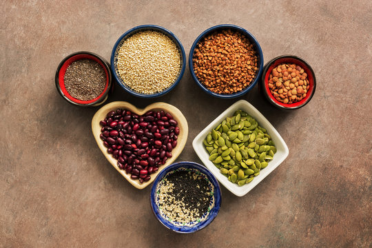 Super food cereals, legumes, seeds on a brown background. Chia, quinoa, beans, buckwheat, lentils, sesame, pumpkin seeds. Top view,flat lay