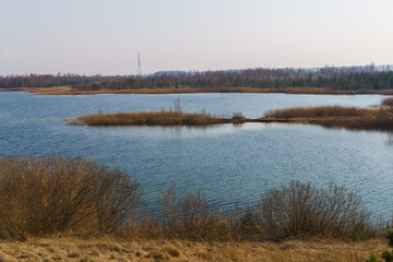 Beautiful view of the lake with blue water in Latvia. Spring landscape.