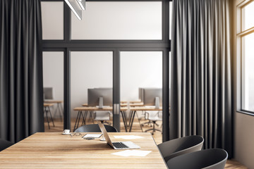 Table with laptop in conference room