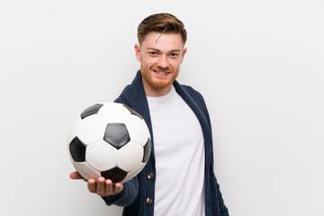 Redhead man holding a soccer ball