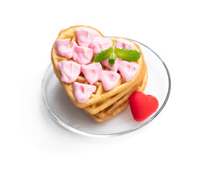 Stack of heart shaped waffles with pink cream isolated on white