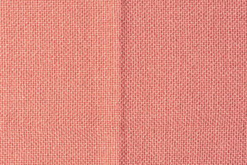 Dark orange fabric closeup. Blank background for layouts with fabric texture. Light photo.